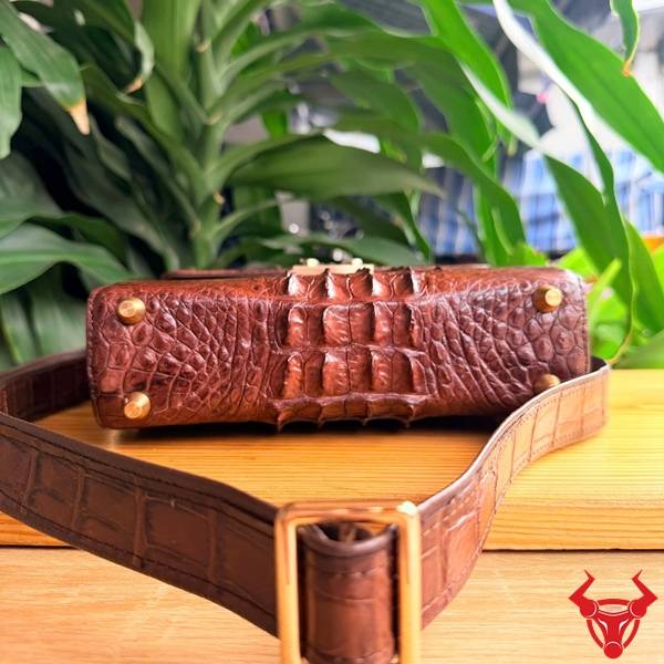 Túi xách nam đeo chéo da cá sấu gù màu nâu đất.